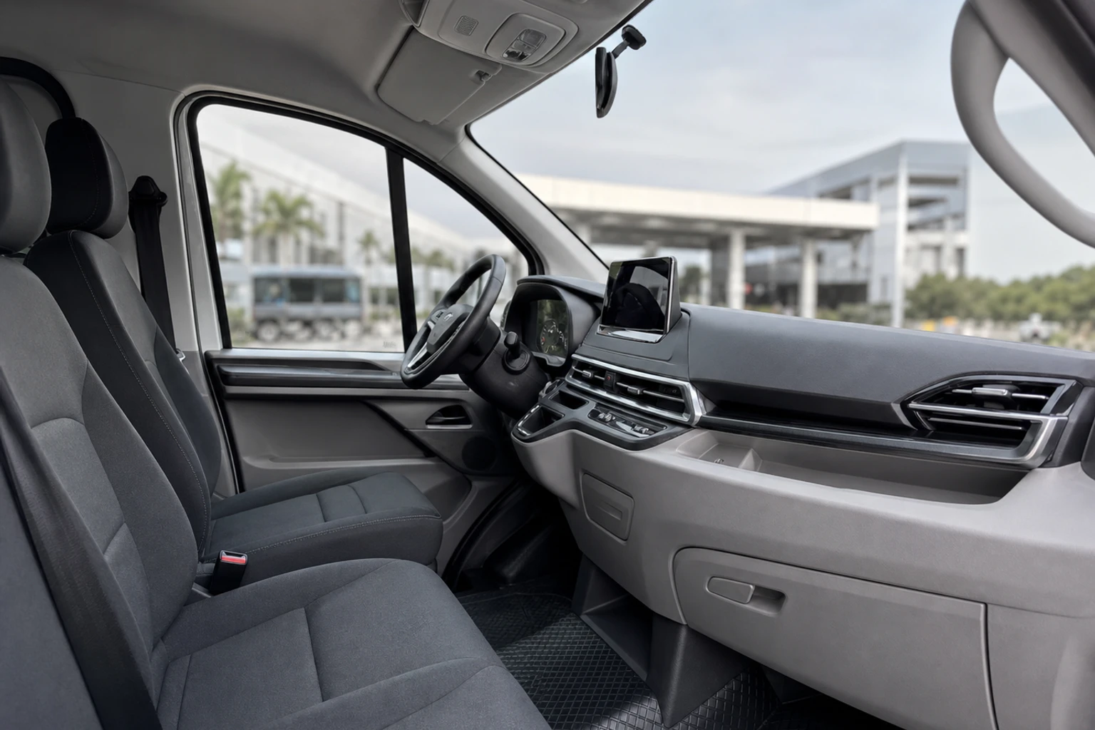 The grey and black driver cockpit inside a CloudLines electric van